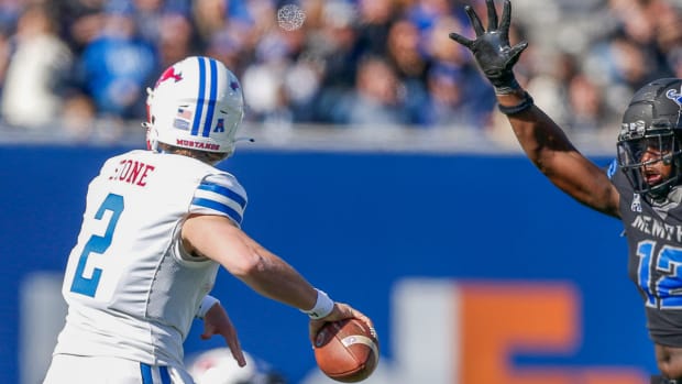 SMU quarterback Rhett Lashlee makes a throw as a Memphis defender closes in
